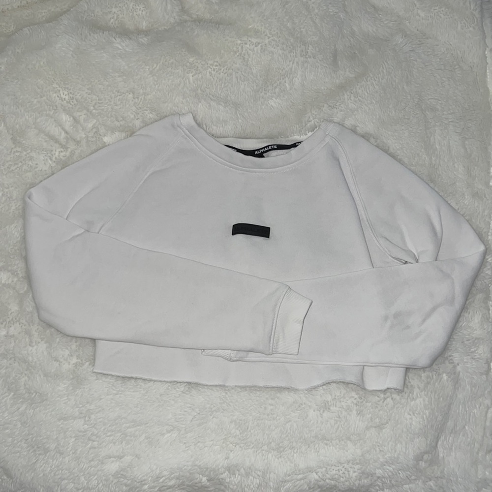 White cropped long sleeve Alphalete sweatshirt. Size XS. Rough cut bottom.